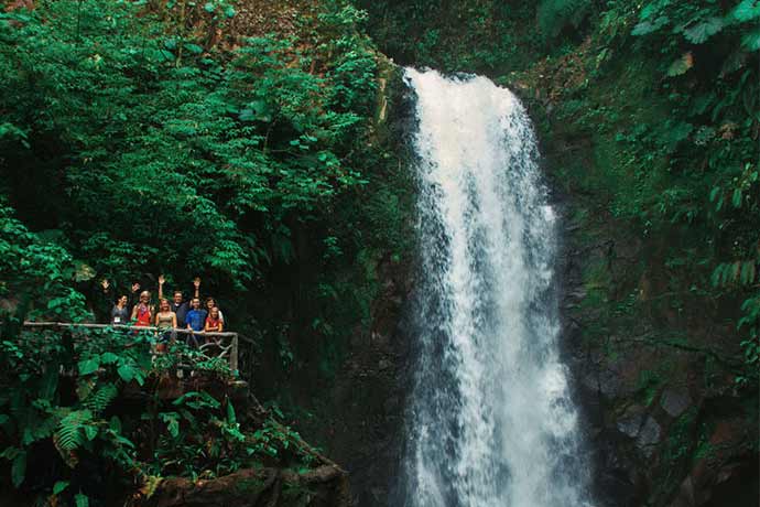 Travelers in Costa Rica enjoying the beatiful waterfalls at La Paz